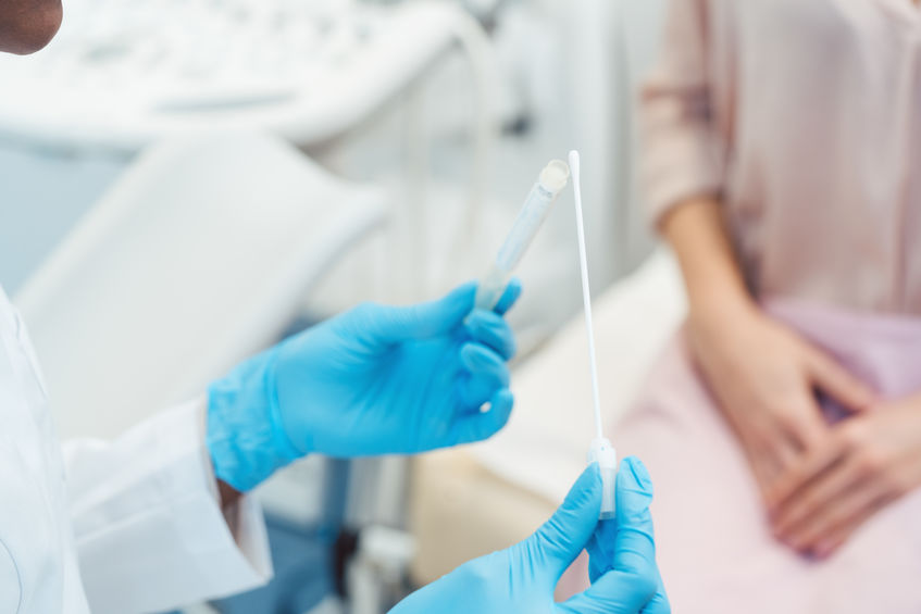 Gynecologist testing vaginal swab for STD, close-up