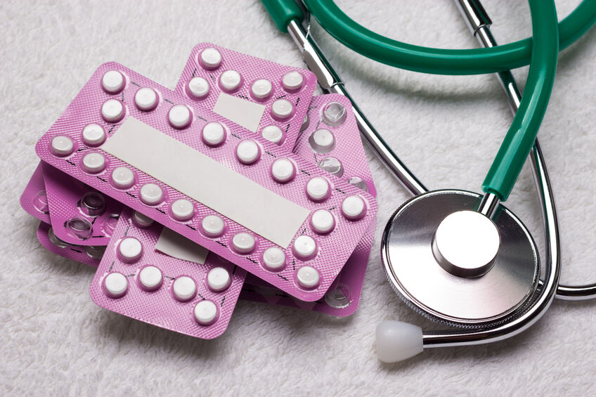 Discarded hormonal birth control packs next to a stethoscope after a patient decides to get off the pill.