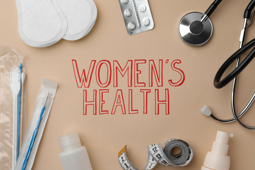 Flat lay composition with sanitary pads, pills near words Women's Health on beige background