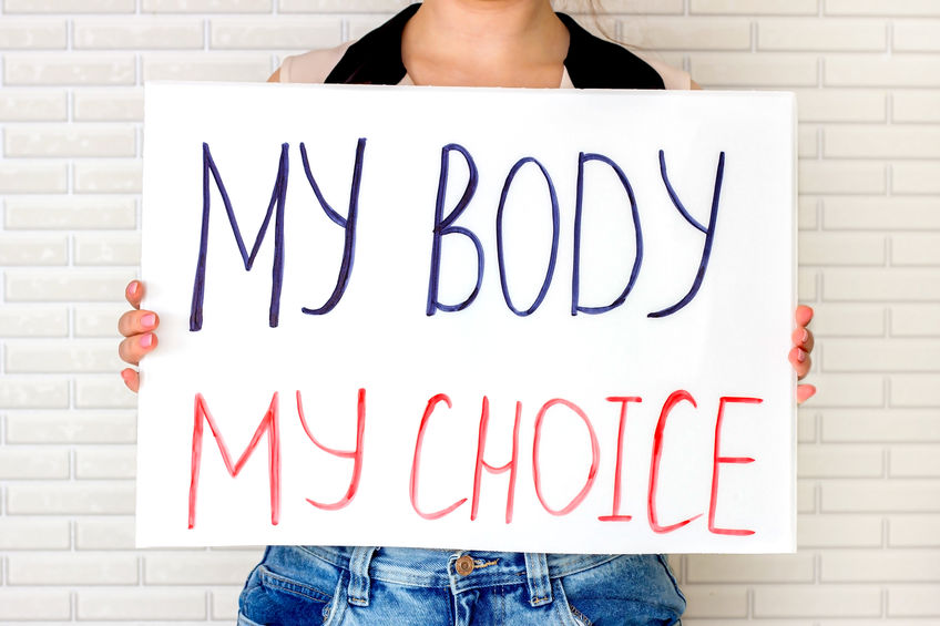 Woman holding a placard with My Body My Choice text.