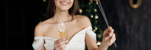 Closeup portrait of a happy pretty woman with champagne, new year and xmas