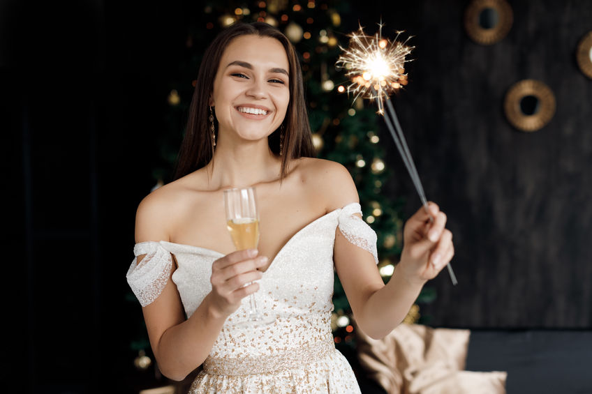 Closeup portrait of a happy pretty woman with champagne, new year and xmas